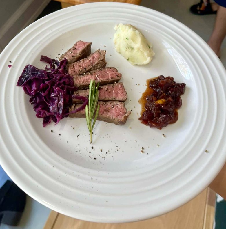 Plated seared steak with braised red cabbage and chutney