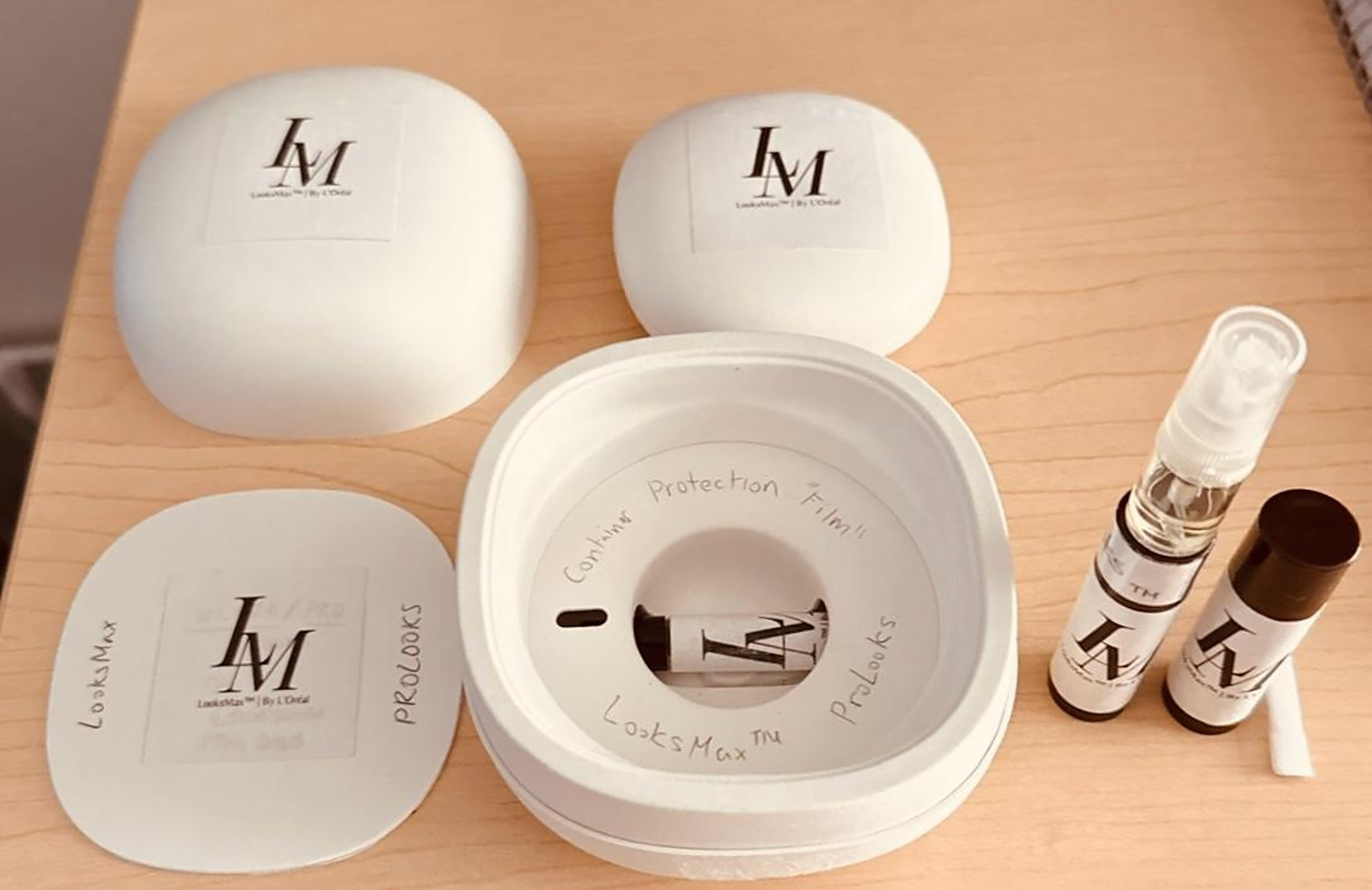 LooksMax prototype — modular case, lids, lip-care stick and fragrance vials laid out